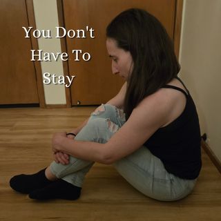 Woman sitting on floor, head resting on knees